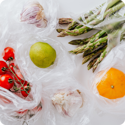 Lemons, tomatoes, asparagus, and other vegetables are on the table