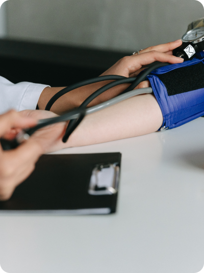 An individual using a stethoscope to check the heart rate of another person